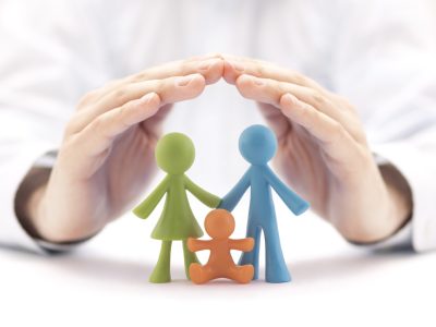 Family,Insurance,Concept,With,Colorful,Family,Figurines,Covered,By,Hands